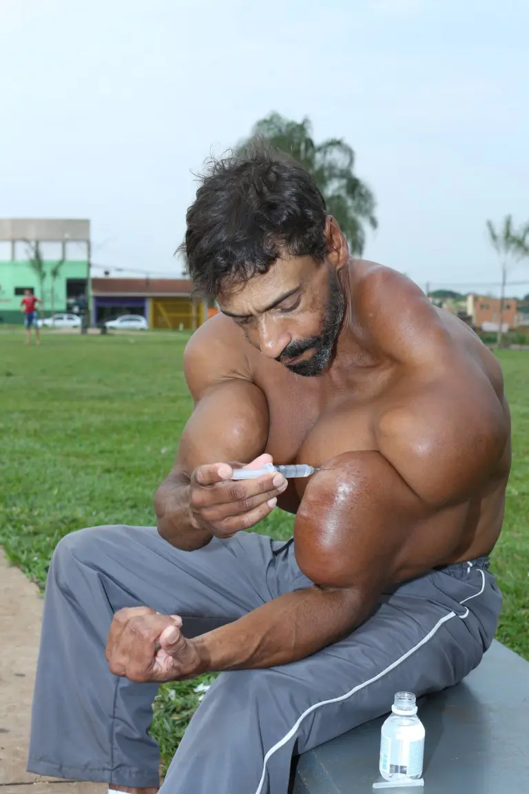 He injects synthol into his bicep (Picture: Barcroft)