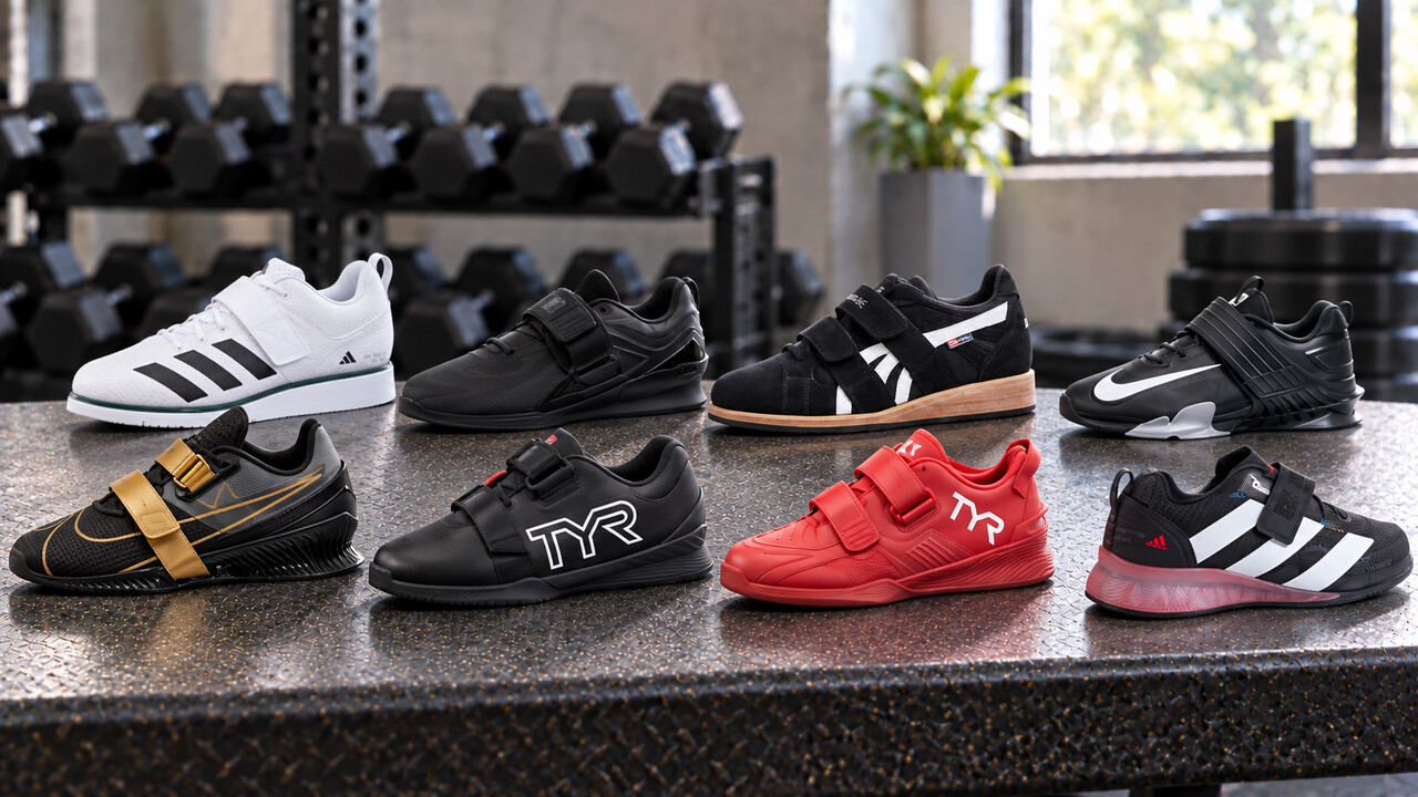 Eight weightlifting shoes with distinct straps and raised heels arranged on a gym bench