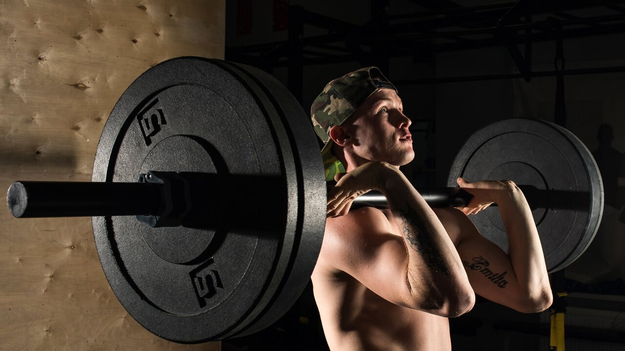 Lifter holding a barbell in the front rack after a clean