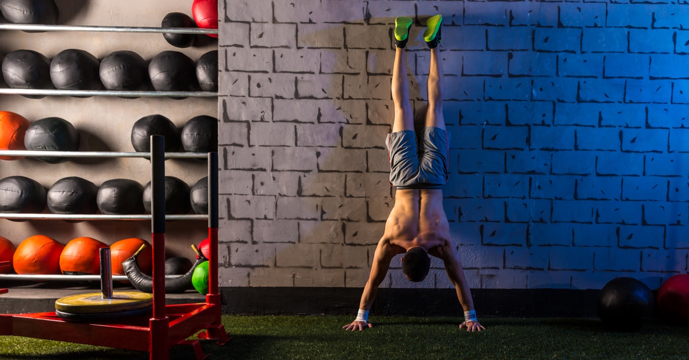How To Do a Handstand Push-up, According to CrossFit Coaches.