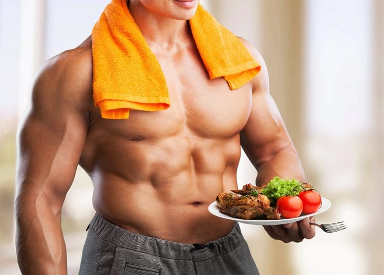 Bodybuilder Holding Plate With Meat And Vegetables