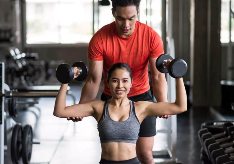 Personal Trainer Coaching Dumbbell Exercise