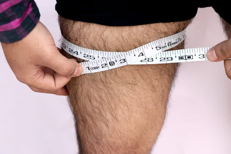 Adult Man Measuring His Thigh With Tape