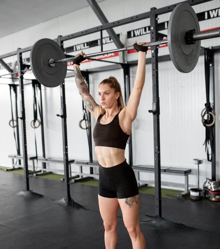 Woman Training With Barbell Press