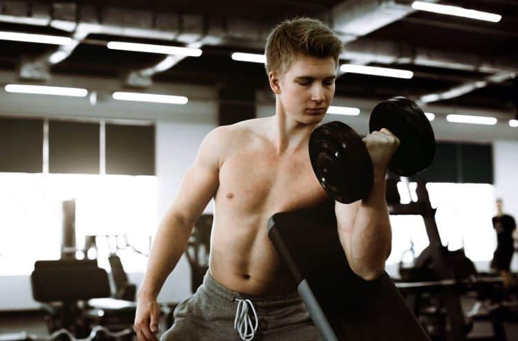 Young Man Doing Dumbbell Curls