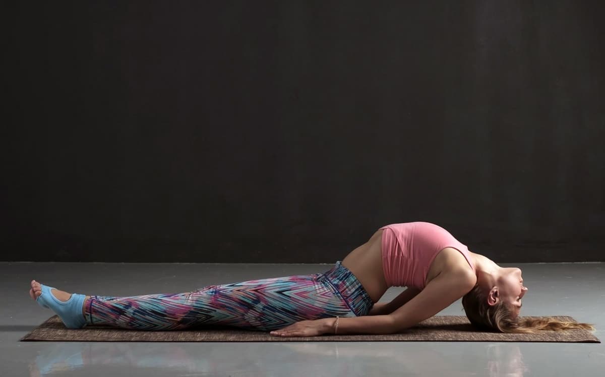 Premium Photo | Woman practices yoga asana matsyasana fish pose