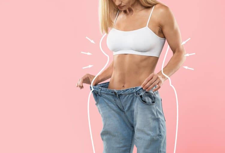 Lady In Oversized Jeans Checking Weight Loss