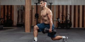 Man Doing Lunges With Heavy Dumbbells
