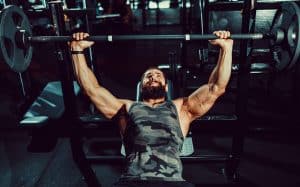 Man Doing Bench Press In Gym