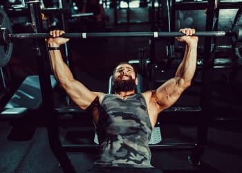 Man Doing Bench Press In Gym