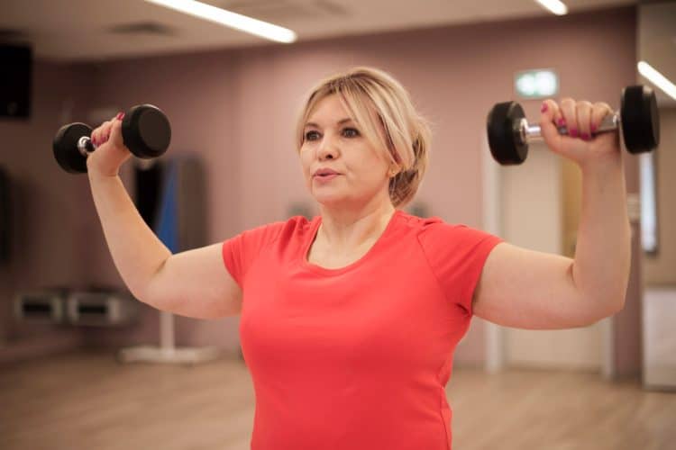 Woman Training With Dumbbells