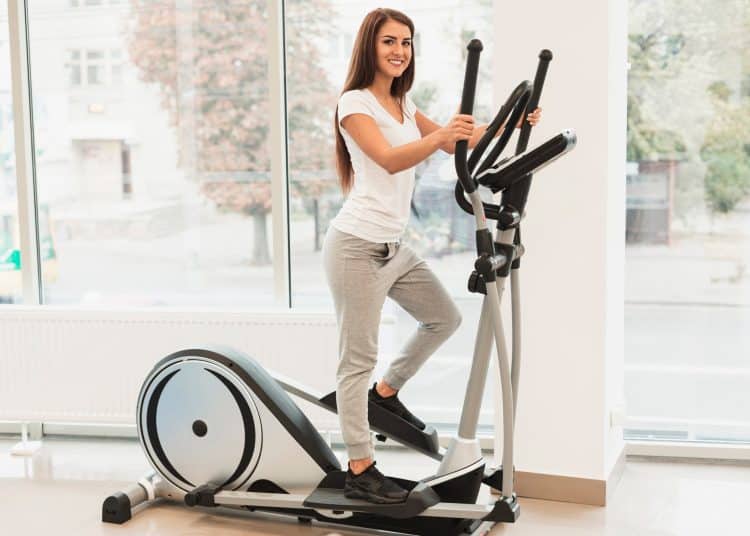 Woman Exercising Using Elliptical Machine