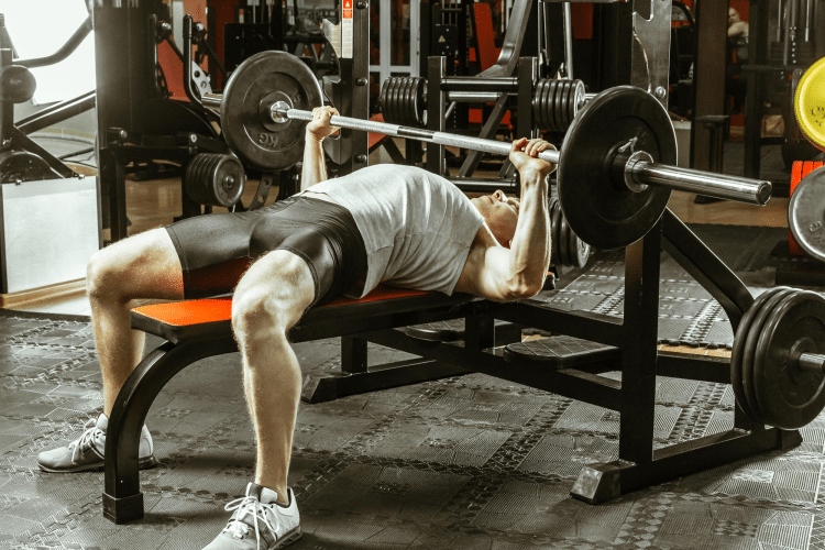Man Doing Bench Press In Gym