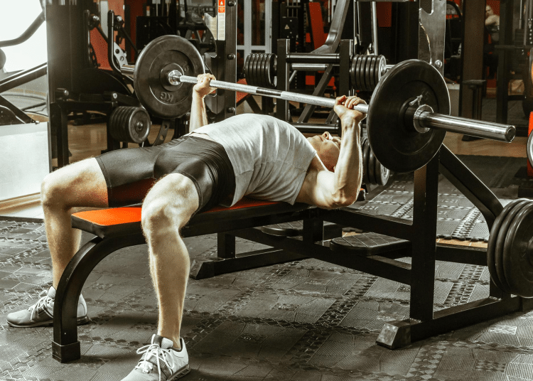 Man Doing Bench Press In Gym