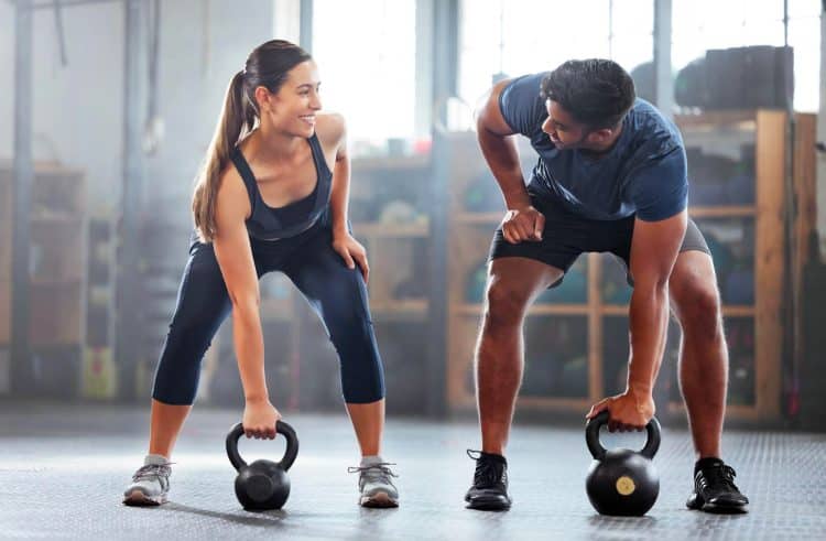 Couple Doing Kettlebell Weight Training