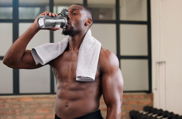 Man Drinking Water In Gym