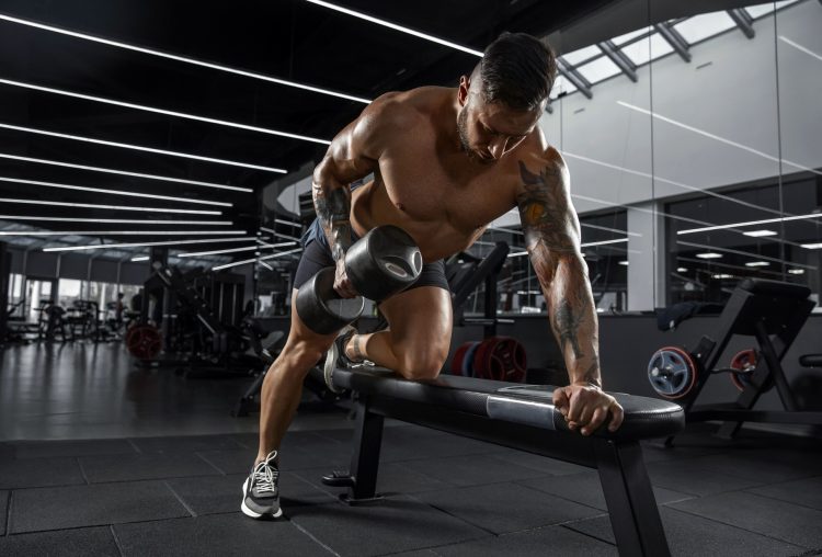 Muscular Athlete Exercising In Gym