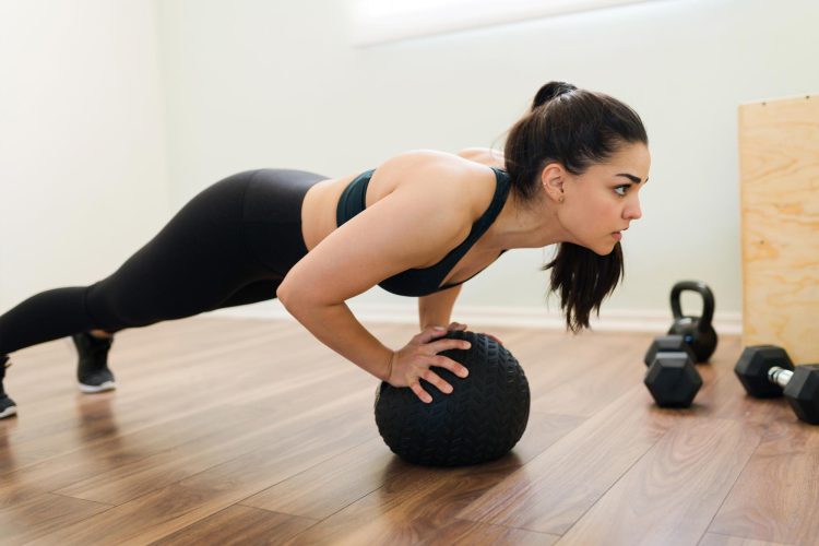 Woman Doing Push Ups With Med Ball