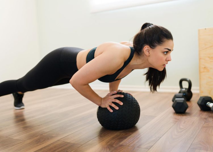 Woman Doing Push Ups With Med Ball
