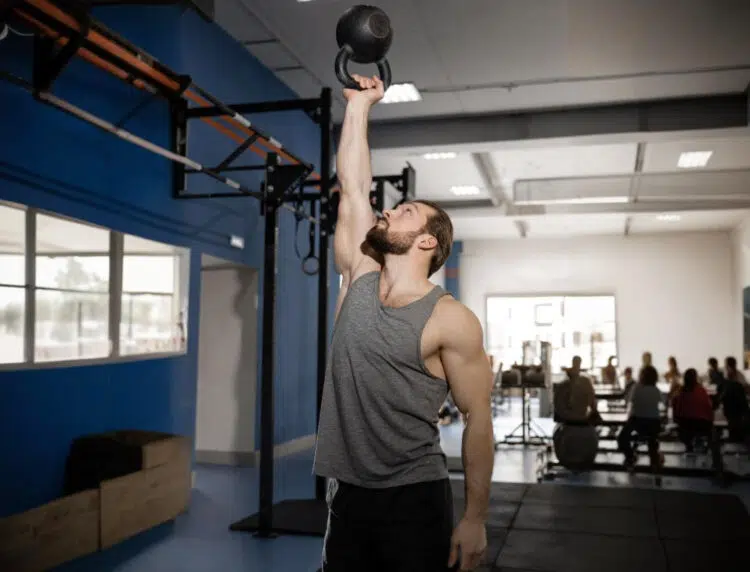 Man Perform Bottoms Up Kettlebell Press