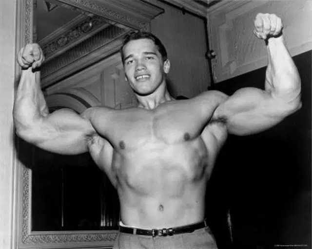 Young Arnold Showing Biceps