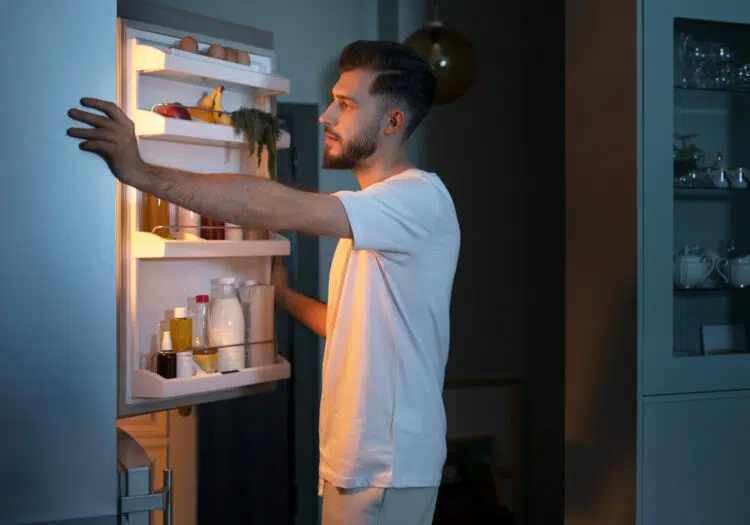 Man Looking For Snacks In The Fridge