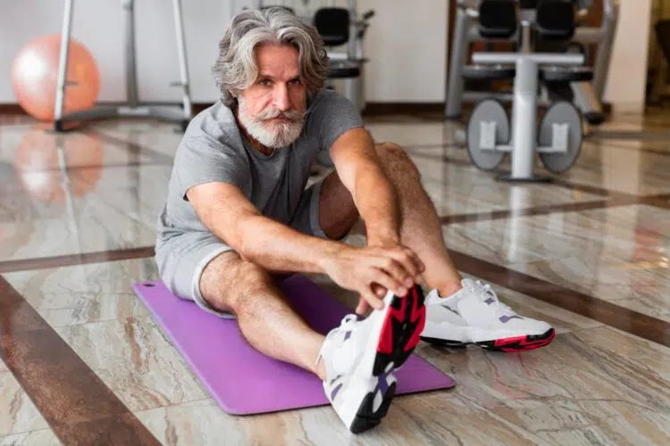 Older Man Stretching at Gym