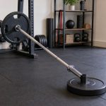 DIY landmine attachment setup with barbell sleeve secured in a stable base on rubber flooring