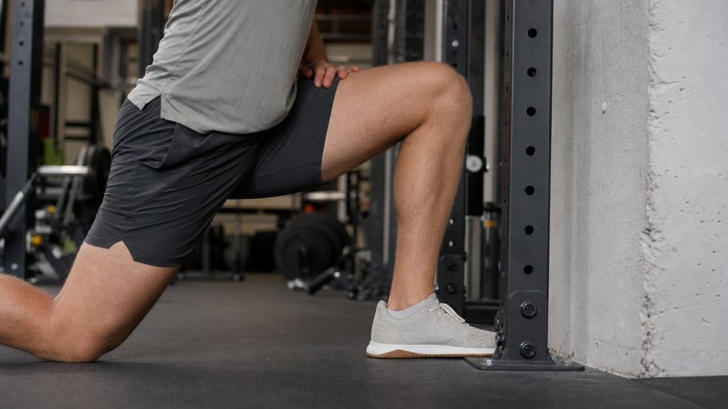 The knee-to-wall test helps lifters check ankle mobility before changing squat stance or shoes.