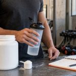 Creatine monohydrate scoop and shaker on a gym counter for a creatine claims fact check