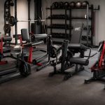 Leg extension and curl machines arranged in a FitnessVolt home gym review scene
