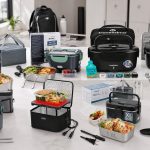 Packed meal container beside a portable electric food warmer and work bag