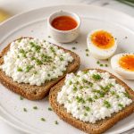 Cooked eggs served on cottage cheese toast