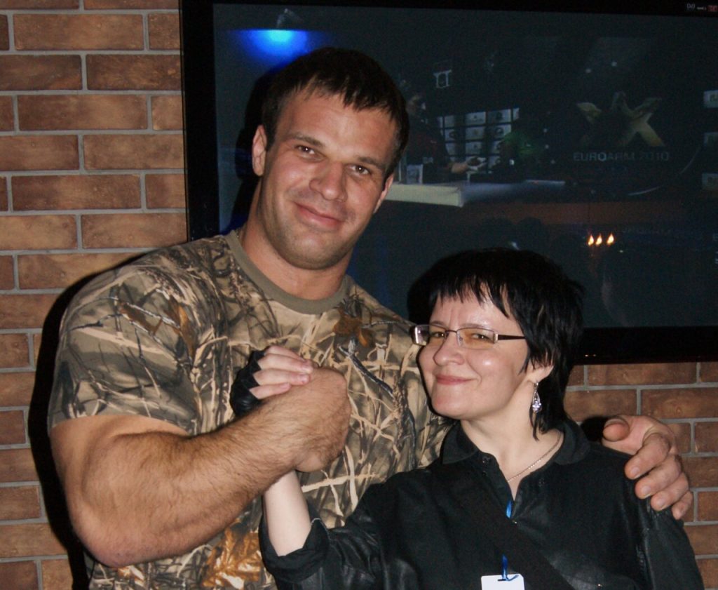 Denis Cyplenkov posing indoors with a woman at the 2011 Russian Armwrestling Championship