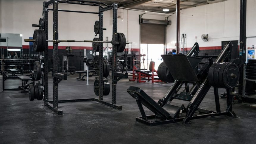 Power rack and plate-loaded leg press in a strength gym
