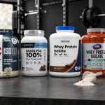 Whey isolate protein tubs on a gym counter