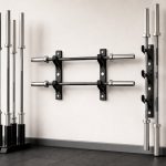 Barbell storage racks organizing Olympic and specialty bars in a bright home gym