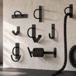 Battle rope anchor and coiled rope set up in a bright home gym