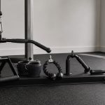 Cable machine attachment sets arranged in a bright organized home gym