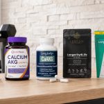 Calcium AKG supplement bottles with visible labels on a bright fitness studio counter
