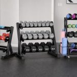 Dumbbell rack with neatly organized hex dumbbells in a compact home gym