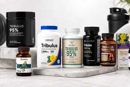 Tribulus terrestris supplement bottles arranged beside a training notebook and measuring scoop