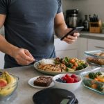 Lifter logging a meal with chicken, rice, vegetables, fruit, and dessert