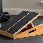 StrongTek wooden slant board in a practical home gym