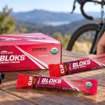 CLIF BLOKS Strawberry 18-pack and sealed packets beside cycling gear