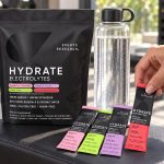 Sports Research Hydrate variety pouch and packets beside a water bottle