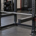 Barbell resting on spotter arms attached to a power rack
