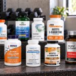 Ten acetyl-l-carnitine supplements arranged on a gym bench