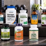 Ten Bacopa supplement bottles arranged on a metal workout bench.